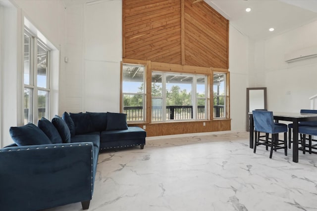 living room with marble finish floor, recessed lighting, wooden walls, a wall mounted AC, and a high ceiling