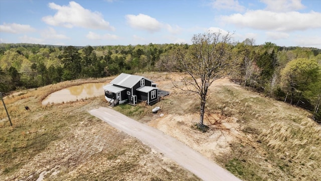 birds eye view of property with a wooded view