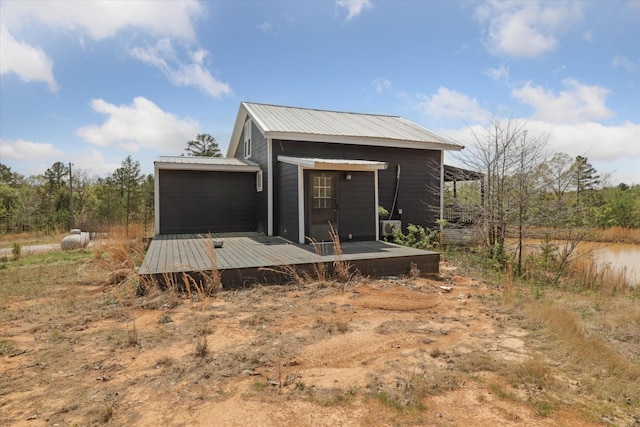 back of property with a deck and metal roof