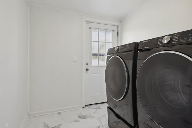washroom featuring baseboards, marble finish floor, washer and dryer, crown molding, and laundry area