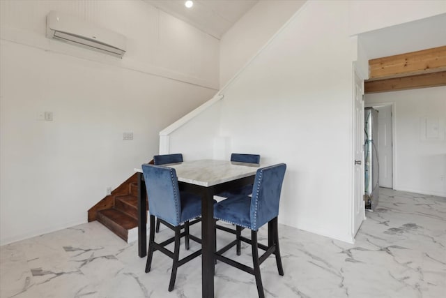 dining area featuring marble finish floor and a wall mounted AC