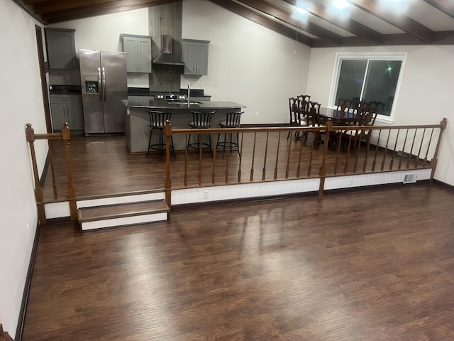 dining space with baseboards, dark wood-style flooring, and lofted ceiling with beams