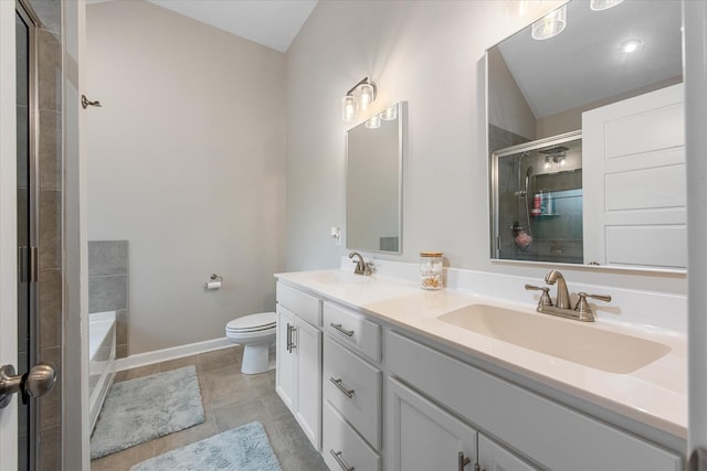 bathroom featuring tiled shower, toilet, lofted ceiling, baseboards, and double vanity
