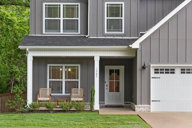 property entrance with board and batten siding, covered porch, a shingled roof, and fence