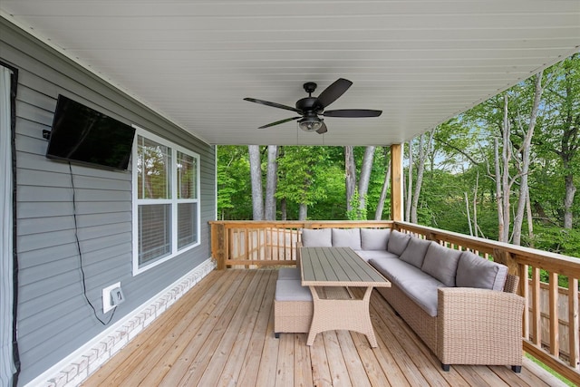 wooden deck featuring outdoor lounge area and ceiling fan