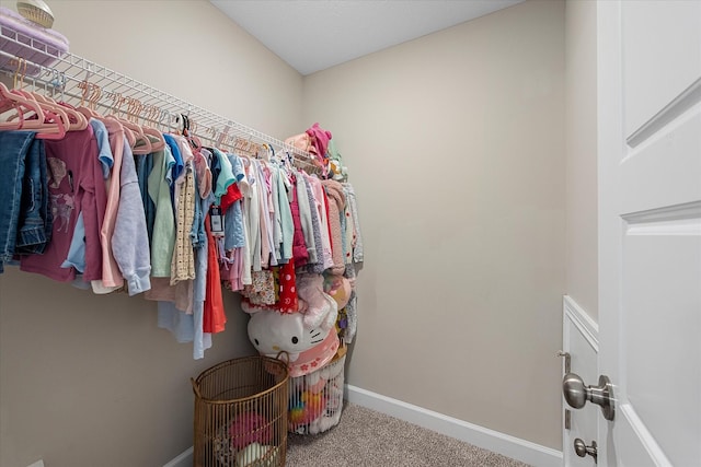 walk in closet with carpet