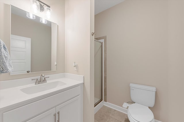 bathroom with a shower stall, toilet, baseboards, vanity, and tile patterned floors