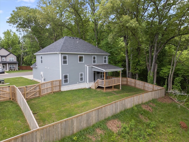 rear view of property featuring roof with shingles and a wooden deck