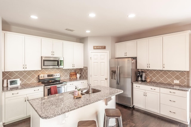 kitchen featuring a sink, dark wood-style flooring, stainless steel appliances, and white cabinets