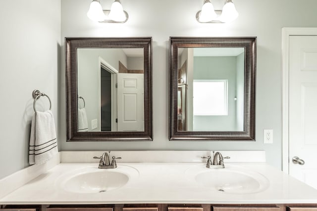 bathroom with a sink and double vanity