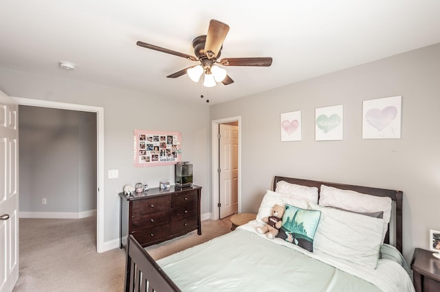 bedroom with light carpet, baseboards, and a ceiling fan