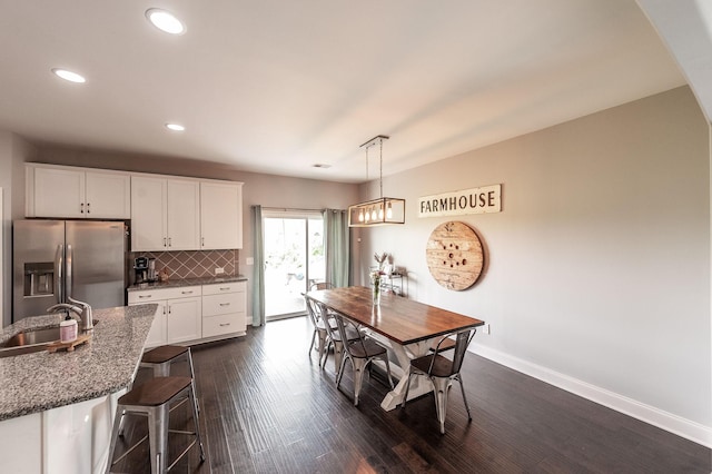 dining area with baseboards, dark wood finished floors, and recessed lighting