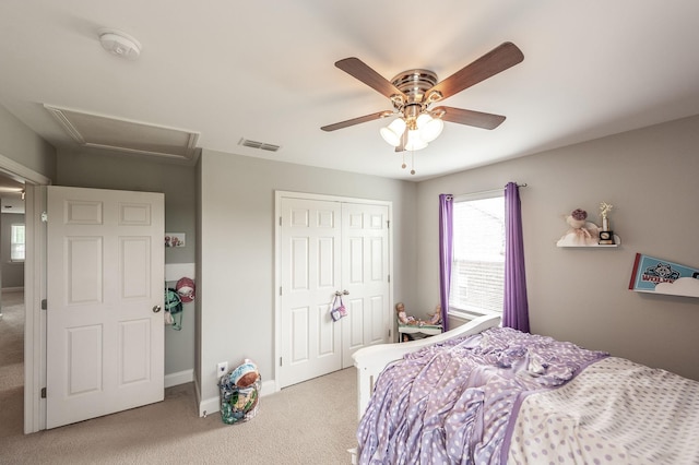 bedroom with a closet, carpet, attic access, visible vents, and baseboards
