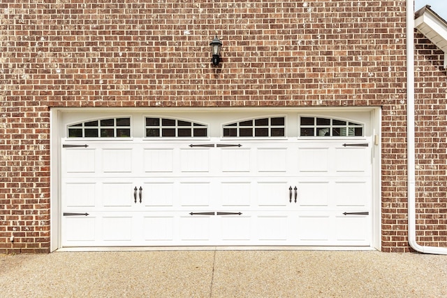garage featuring concrete driveway