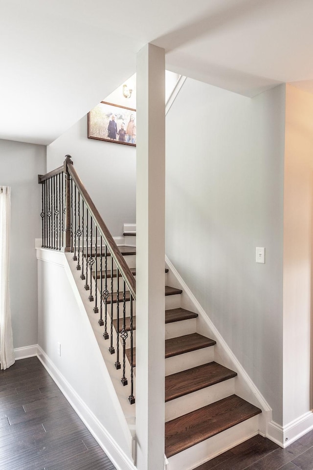stairs with baseboards and wood finished floors