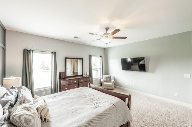bedroom with baseboards, ceiling fan, visible vents, and carpet floors