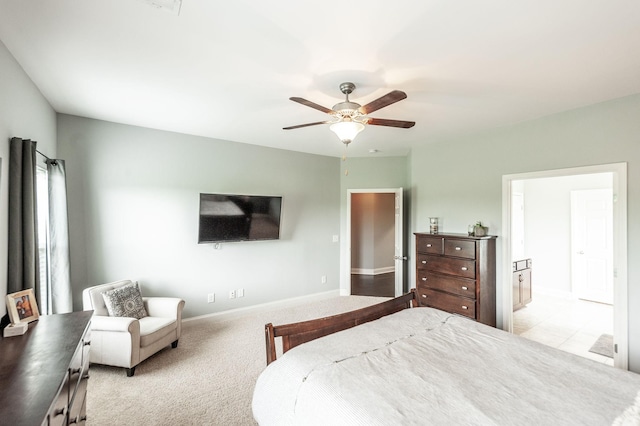 bedroom featuring light carpet, baseboards, and ceiling fan