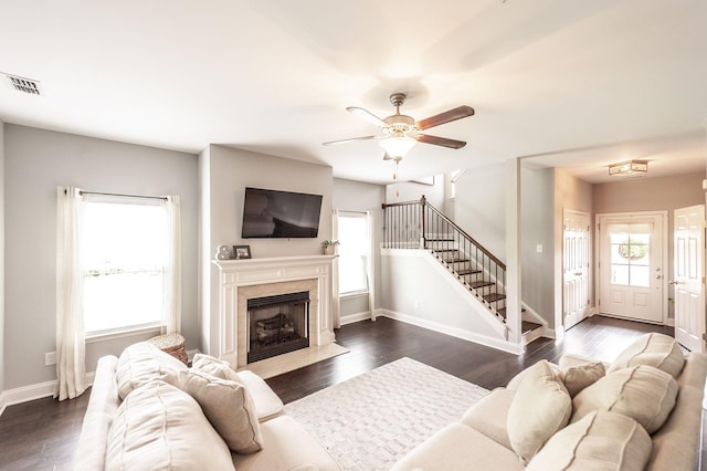 living area featuring stairway, ceiling fan, visible vents, and dark wood finished floors