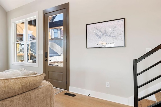 48 Hasty Hill Rd, Lynchburg, TN 37352 - doorway to outside with light wood-type flooring, baseboards, visible vents, and stairway