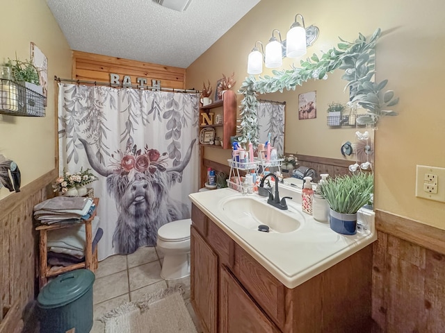 130 Wayne Threatt Rd, Dover, TN 37058 - full bath with toilet, tile patterned floors, vanity, wood walls, and a wainscoted wall