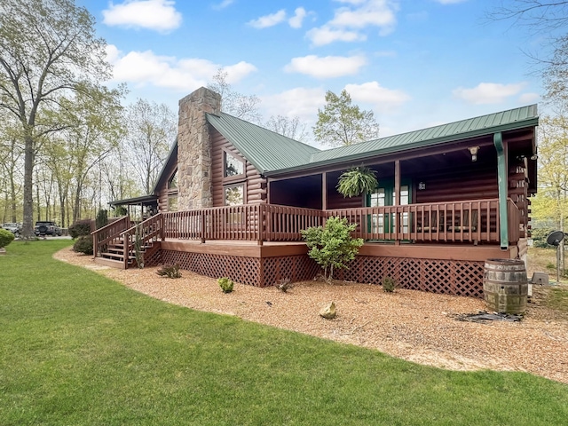 130 Wayne Threatt Rd, Dover, TN 37058 - back of property with log siding, a deck, a yard, metal roof, and a chimney