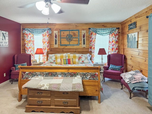 130 Wayne Threatt Rd, Dover, TN 37058 - carpeted bedroom featuring multiple windows, a textured ceiling, wooden walls, and ceiling fan