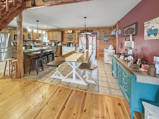 130 Wayne Threatt Rd, Dover, TN 37058 - dining space with light wood-style floors, wood walls, and a textured ceiling