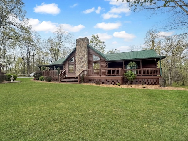 130 Wayne Threatt Rd, Dover, TN 37058 - rear view of house with a lawn, a chimney, metal roof, and log exterior