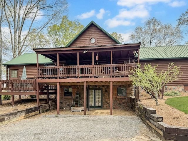130 Wayne Threatt Rd, Dover, TN 37058 - back of property featuring metal roof, a wooden deck, stone siding, and log veneer siding