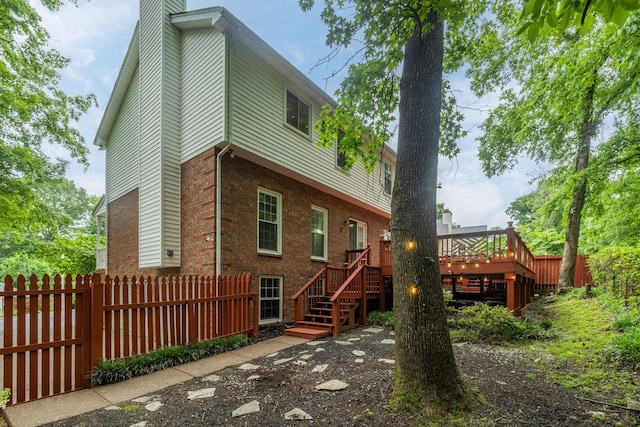 429 Old Oak Way, Hermitage, TN 37076 - back of property with a deck, stairway, brick siding, a chimney, and fence