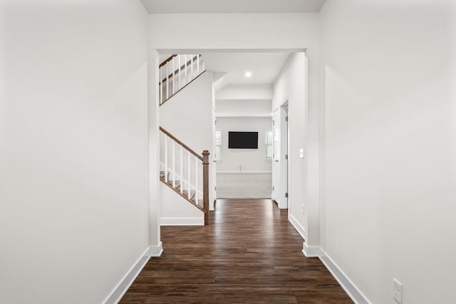 hall featuring baseboards, dark wood-style flooring, stairway, and recessed lighting