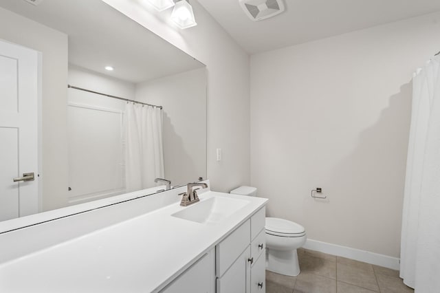 bathroom with toilet, baseboards, visible vents, tile patterned flooring, and vanity