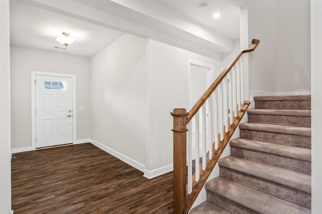 entrance foyer with dark wood finished floors, stairway, and baseboards