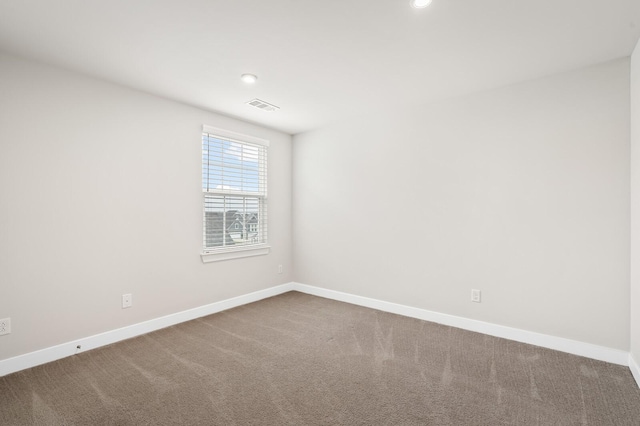 carpeted empty room featuring baseboards, recessed lighting, and visible vents