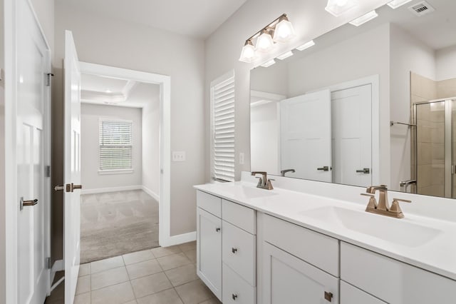 bathroom with a stall shower, visible vents, a sink, and double vanity