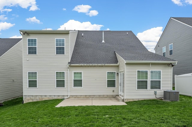 back of house with a lawn, central air condition unit, a patio, and roof with shingles