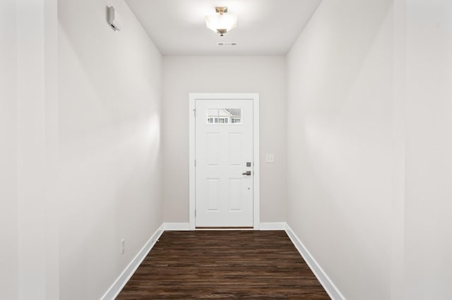 doorway featuring baseboards, dark wood finished floors, and visible vents