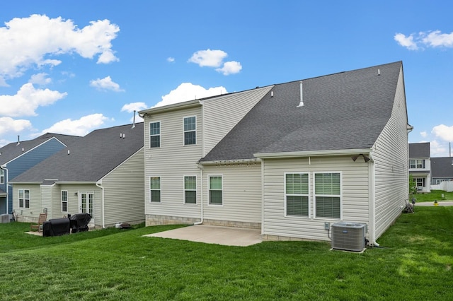 back of property featuring central AC, a patio area, and a yard