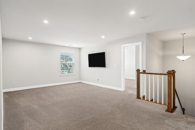 spare room featuring baseboards, carpet flooring, and recessed lighting