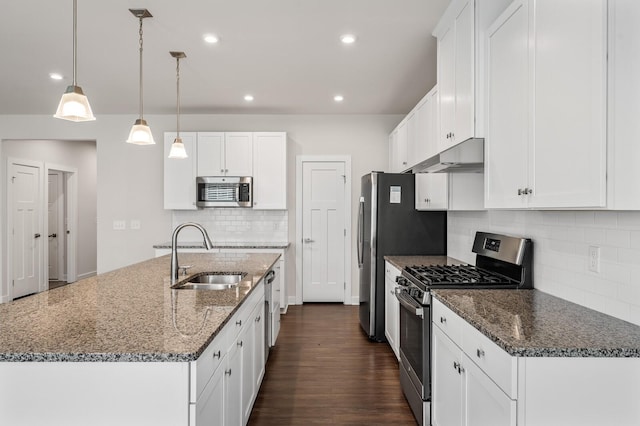 kitchen with under cabinet range hood, white cabinetry, appliances with stainless steel finishes, and a sink