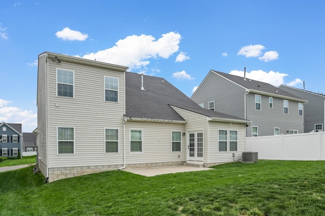 back of house with a lawn, fence, a patio, central air condition unit, and roof with shingles
