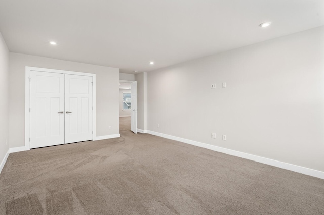 unfurnished bedroom with carpet, baseboards, and recessed lighting