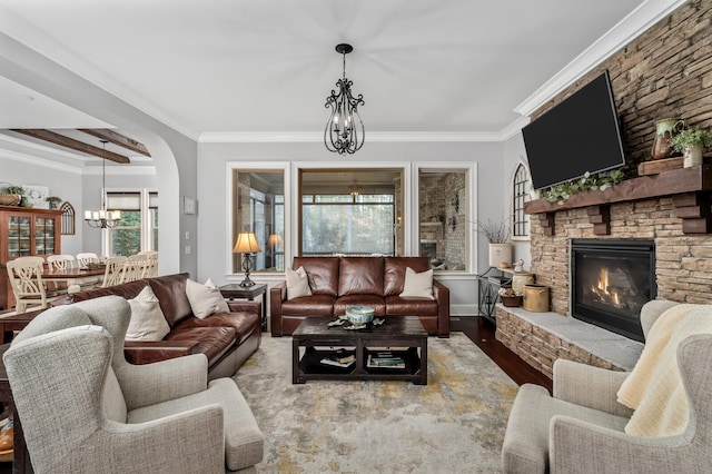 4029 Kings Camp Pass, Arrington, TN 37014 - living area featuring wood finished floors, ornamental molding, a fireplace, an inviting chandelier, and baseboards