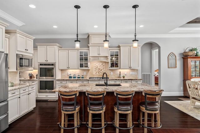 4029 Kings Camp Pass, Arrington, TN 37014 - kitchen featuring arched walkways, stainless steel appliances, dark wood finished floors, and a sink