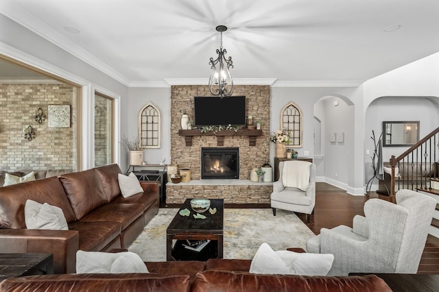4029 Kings Camp Pass, Arrington, TN 37014 - living room featuring a stone fireplace, ornamental molding, arched walkways, stairway, and dark wood-style floors