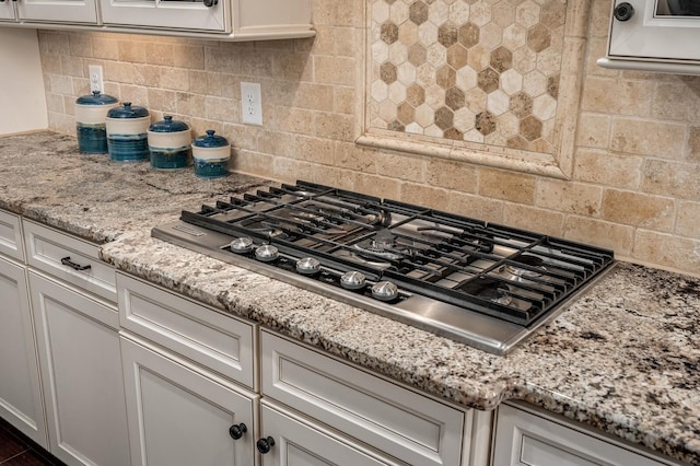4029 Kings Camp Pass, Arrington, TN 37014 - kitchen with stainless steel gas cooktop, backsplash, and white cabinets