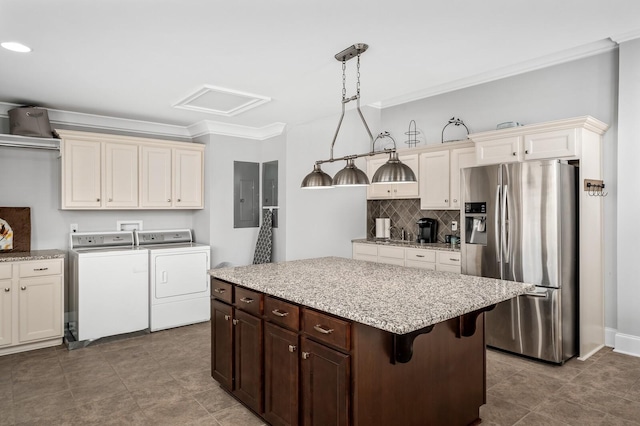 4029 Kings Camp Pass, Arrington, TN 37014 - kitchen featuring electric panel, separate washer and dryer, crown molding, decorative backsplash, and stainless steel fridge with ice dispenser