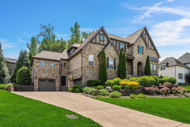 4029 Kings Camp Pass, Arrington, TN 37014 - view of front of house featuring concrete driveway, a front lawn, an attached garage, and stone siding
