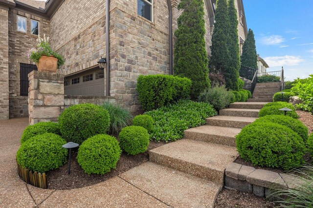 4029 Kings Camp Pass, Arrington, TN 37014 - view of side of home featuring stairway, stone siding, and brick siding