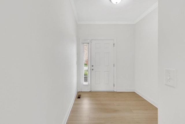 entrance foyer featuring crown molding, baseboards, visible vents, and light wood-style floors